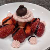 Fresh strawberries, whipped strawberry cream cheese, a drizzle of chocolate, and a Wilbur chocolate bud.